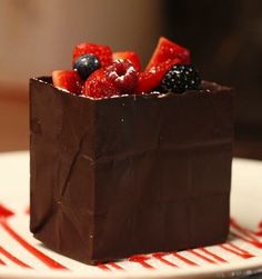 a chocolate dessert with berries and strawberries on top