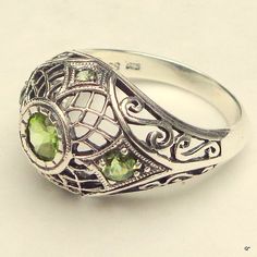 "This is a Stunning, Victorian/Art Deco Design, Vintage Sterling Silver, Filigree, Genuine Peridot Ring.  A Size 6 3/4, the top of the Ring stands up 1/4\" on the finger, and Measures 1/2 x 3/4\"wide. This Vintage Reproduction of a Luxurious Antique Filigree Design is set with five genuine Peridot, the center stone, a bezel set 6mm, and the two side stones are prong set 3.5 mm, and two tiny top and bottom stones.  It was made in the 1970's from the Original Designs of the Victorian/Art Deco Peri Green Gem Ring, Victorian Style Rings, Bauble Bar, Antique Filigree, Green Gem, Green Rings, Alexandrite Ring, August Birthstone, Vintage Style Jewellery