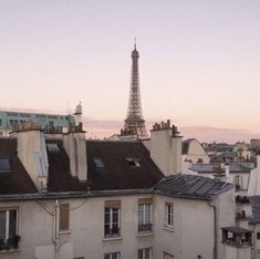 view of the eiffel tower from an apartment building in paris, france at sunset