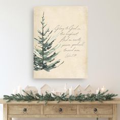 a christmas mantle with candles and greenery in front of a painting on the wall