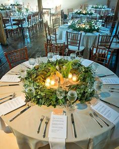 the table is set with silverware and place settings for guests to sit down at