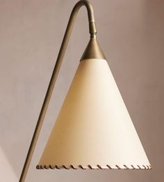 a lamp that is on top of a wooden table next to a white and brown wall