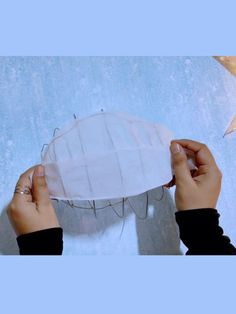 two hands are holding a paper lantern