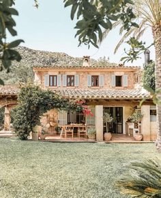 an image of a house that is in the middle of some grass with trees around it