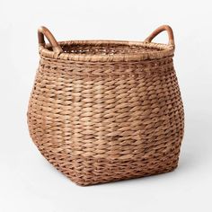 an empty basket with handles on the top and bottom, sitting in front of a white background