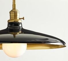 a black and gold light hanging from a ceiling