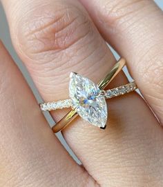 a woman's engagement ring with a pear shaped diamond