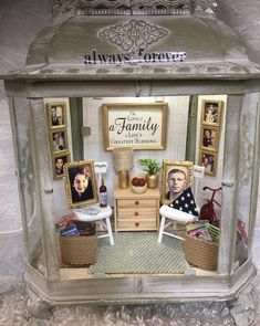 a doll house with pictures and furniture in it