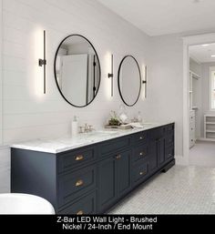 a bathroom with two sinks and three mirrors