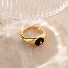 This modern signet ring is sure to get noticed with its bold design and stunning black color. The deep black background and thick ring band is an elegant contrast to the delicately embedded CZ Diamond. It’s both elegant and edgy, making it perfect for any occasion or style. Material: High Quality Solid 925 Sterling Silver Finish: 18K Gold∙Sterling Silver Featuring a ~10mm Black Enamel Signet Ring with an embedded CZ Diamond | Band is ~2.5mm Model showcases a statement, everyday style ring look f Classic Black Open Signet Ring, Black Classic Open Signet Ring, Modern Black Enamel Signet Ring, Modern Black Dome Ring As A Gift, Elegant Black Enamel Ring For Promise, Minimalist Open Ring With Black Enamel, Minimalist Black Signet Promise Ring, Modern Black Dome Ring Gift, Modern Black Open Signet Ring