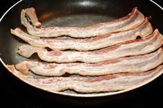 bacon is cooking in a frying pan on the stove