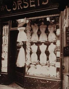 an old fashion store front with mannequins in the window