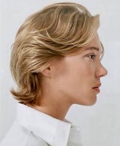 a woman with blonde hair wearing a white shirt and looking off to the side in profile