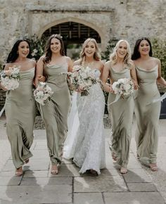 bridesmaids in sage green dresses walking down the aisle with their bouquets on