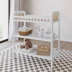 a baby changing table with a teddy bear on it