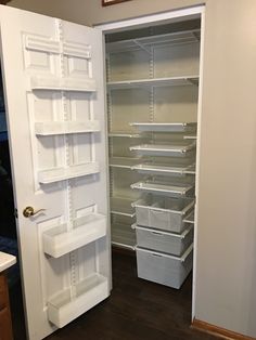 an empty pantry with shelves and bins in it