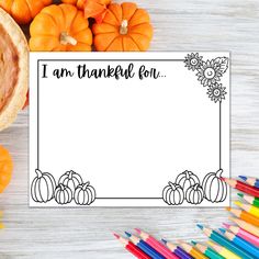 a thanksgiving greeting card with pumpkins and other autumn decorations on a white wooden table