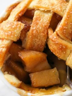 a close up of a pie in a bowl with a spoon