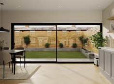 an open living room and dining area with sliding glass doors that lead to the backyard