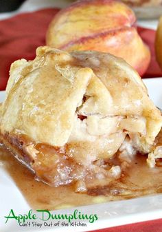 an apple dumpling on a plate with apples in the background