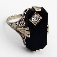 "Vintage 14 K (.585) white gold long ring, having open-work floral design setting with chamfered rectangle form Onyx centerpiece, accented with Diamond inset. The Diamond is 0.23ct., color J, SI1 clarity. This impressive ring is a size 8, 13/16\" long and weighs 3.2 grams. EA1807" Formal Fine Jewelry Rings With Rectangular Stone, Fine Jewelry Rectangular Diamond Ring For Formal Occasions, Rectangular Platinum Ring For Formal Occasions, Elegant Formal Jewelry With Rectangular Stone, Elegant Jewelry With Rectangular Stone For Formal Occasions, Elegant Rectangular Stone Formal Jewelry, Formal Sterling Silver Rectangular Diamond Ring, Rectangular Sterling Silver Diamond Ring For Formal Occasions, Elegant Rectangular Filigree Jewelry