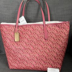 Brand New With Tag Coach Signature Tote Handbag Purse Grain Leather Rouge (Pink) Color Polished Gold Hardware Coach Logo & Medallion On The Front Snap Closure On The Top Interior: One Zip Pocket Approximately 13”-17”L X 11.5”H X 6"W Durable & Roomy Smoke & Pet Free Home Retail Price $398+Tax Please See My Entire Collection . Large Capacity Monogram Canvas Bag, Monogram Canvas Shopping Bag, Tan Monogram Canvas Bag For Shopping, Tan Monogram Canvas Shopping Bag, Monogram Canvas Shopping Bag With Branded Hardware, Daily Use Monogram Canvas Shoulder Bag With Logo, Logo Tote Bag For Shopping, Luxury Pink Coated Canvas Shoulder Bag, Pink Monogram Canvas Shoulder Bag For Daily Use