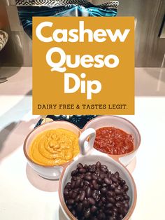 three bowls filled with beans and sauces on top of a white counter next to a sign that says cashew queso dip