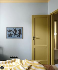 a bedroom with blue walls and yellow doors