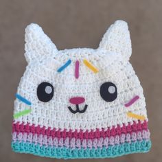 a crocheted cat hat hanging from a hook