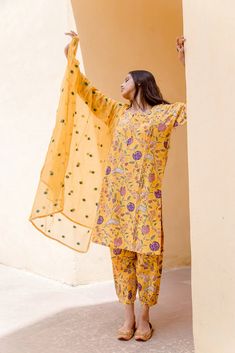 Cotton Yellow Printed Suit Set with Doriya Dupatta The set consists of printed kurta teamed with matching printed pajama and a doriya dupatta with embroidery detailing Kurta Length-39 inches Palazzo Length-34 inches Dupatta Length-2.5 meters Work-Print Detailing Color-Yellow Kurta Fabric-Cotton Bottom Fabric-Cotton Dupatta Fabric-Doriya Model Size- 5.8 tall wearing small size Sleeves - 3/4th Sleeves Neck-Round neck Washing Care-Hand wash or Dry Clean Designer Yellow Palazzo Set With Printed Motifs, Yellow Chikankari Embroidered Palazzo Set, Cotton Silk Kurta With Printed Motifs In Traditional Drape, Designer Yellow Kurta With Printed Motifs, Designer Wear Yellow Kurta With Printed Motifs, Diwali Cotton Silk Palazzo Set With Chikankari Embroidery, Yellow Unstitched Chanderi Palazzo Set, Cotton Silk Kurta With Printed Motifs For Eid, Yellow Cotton Silk Sets With Zari Work