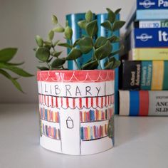 a potted plant sitting on top of a table next to books