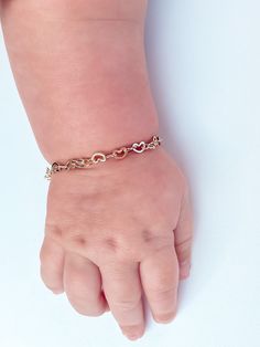 "The perfect Valentine's gift for any special little ladies in your life! Small hearts linked together.  All bracelets are made to order. Processing time is typically 24 hours during business days. Made with 14k filled gold that is hypoallergenic and tarnish resistant. The sizes suggested by age are what fits most. For best fit, measure around the wrist snugly using a string. Then measure the string and add ½ inch to the size. This will help get the most comfortable fit.  Each bracelet has a ½ inch of extender chain for room to grow.  Size Chart: Newborn: 3.5\" 0-6 Months: 4\" 6-12 Months: 4.5\" 1-2 Months: 5\" 2-6 Months: 5.5\" Girls (6 6\" Adult S: 6.5\" Adult M: 7\" Adult L: 7.5\" If you have any questions, please message me.  Do not leave bracelets on babies and toddlers unsupervised." Adjustable Gold Name Bracelet With Heart Charm, Hypoallergenic Heart-shaped Name Bracelet For Mother's Day, Mother's Day Heart-shaped Hypoallergenic Name Bracelet, Cute Rose Gold Bracelets For Valentine's Day, Adjustable 14k Gold Bracelet With Heart Charm, Gold Hypoallergenic Heart Bracelet As Gift, Hypoallergenic Heart Bracelet For Birthday And Mother's Day, Hypoallergenic Yellow Gold Heart Bracelet For Gift, Personalized Heart-shaped Gold Bracelet