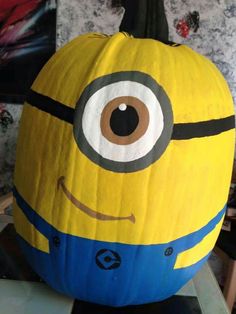 a yellow and blue paper mache sitting on top of a wicker chair