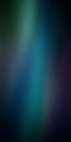 a blurry image of blue, green and purple colors on a black background with white highlights