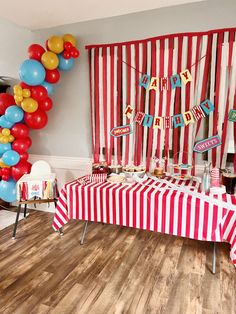 a red and white striped birthday party with balloons