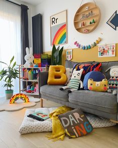 a living room filled with lots of colorful pillows