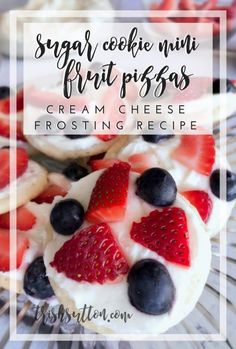 strawberry shortbreads with cream cheese frosting and fresh berries on top, sitting on a glass plate