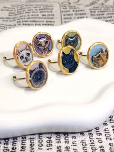 Special hand-drawn pet portrait rings, perfect for a gift to pet lovers! Each ring contains a detailed pet portrait, made with shrink plastic, covered by clear UV resin, framed by solid golden paint,  and combined with an adjustable open 304 stainless steel ring. The resin also creates a 3D effect on the pet's head, making it more detailed and special. There are 12 ready-made designs, 6 dogs, and 6 cats, as shown in the pictures. You can order one of them, or customize a unique one by sending me Pet Jewelry, Golden Painting, Hand Painted Jewelry, Cat Portrait, Dog Jewelry, Ring Hand, Shrink Plastic, Cat Portraits, Mini Paintings