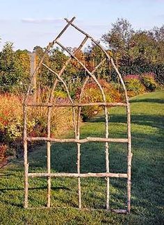 an old iron garden trellis in the grass