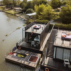 two floating houses on the water surrounded by trees