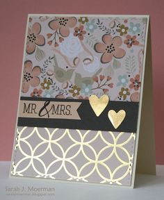 a close up of a card with flowers and hearts