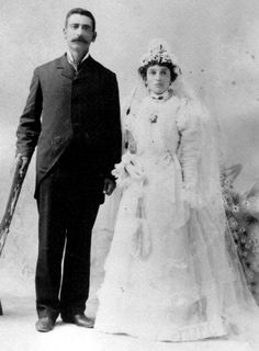 an old black and white photo of a man and woman dressed up for their wedding