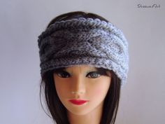 a mannequin head wearing a gray knitted hat