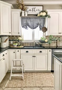 a kitchen with black and white checkered curtains on the window sill above the sink