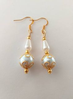 Victorian gold Pearl wedding earrings gold earrings Victorian earrings filigree Earrings Bohemian earrings bridal white pearl gift for her Beautiful Victorian filigree gold tone ornaments and crystal white pearls earrings. Filigree earrings.  Dangle earrings. Drop earrings . Boho earrings. Bohemian earrings . Gold - tone and crystal  pearls Boho earrings . Vintage style earrings . Oriental earrings . Baroque earrings . Antique style earrings .   Wedding earrings. Bridal earrings. We can make the same style beautiful jewelry set if you want - necklace, earrings and bracelet. If you want that, send us a convo/message/. FREE SHIPPING  Material : gold tone ornaments beads, crystal white pearls, plastic beads. Length with hooks : 2 ( 5 cm) If you have any question, please contact me ! Thank you White Gold-plated Pierced Pearl Earrings, White Gold Plated Pierced Pearl Earrings, White Elegant Earrings For Festive Occasions, White Intricate Drop Earrings, Elegant White Earrings For Festive Occasions, White Dangle Bridal Earrings With Intricate Design, White Gold-plated Dangle Pearl Earrings, White Bridal Dangle Earrings With Intricate Design, Delicate White Gold Plated Pearl Earrings