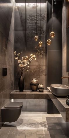 a modern bathroom with two sinks and a large vase filled with flowers on the counter