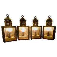 three old fashioned lanterns with lights on them