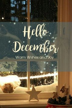 a window with the words hello december written in front of it and snow falling outside