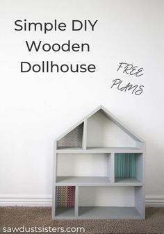 a simple diy wooden dollhouse with free plans on the wall and text overlay