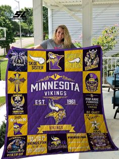 a woman holding up a minnesota quilt in front of a house with the minnesota viking team on it